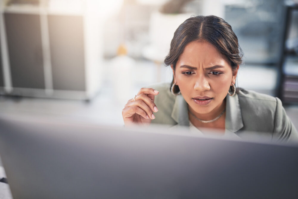 Shot Of An Attractive Young Businesswoman Sitting In The Office And Looking Confused While Using Her Computer