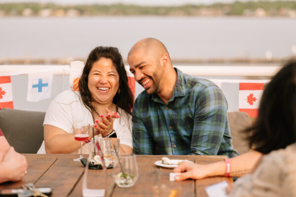 Two people laughing on a patio