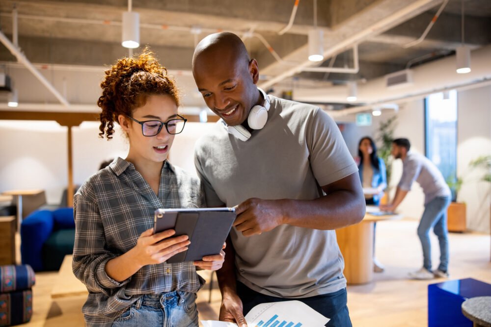 Team of workers looking at a business plan on a tablet