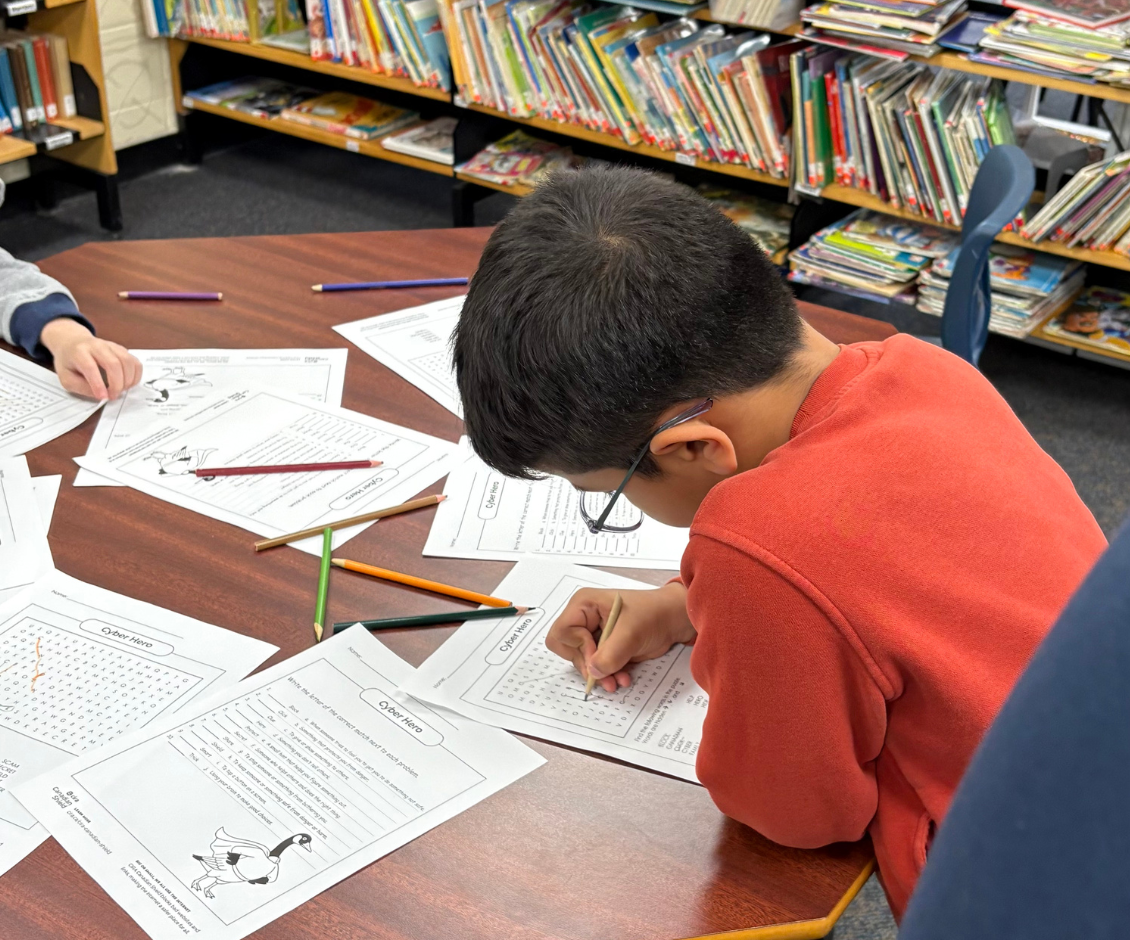 Kid filling out CIRA's cyber worksheets