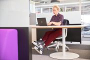 Woman in skates works on laptop