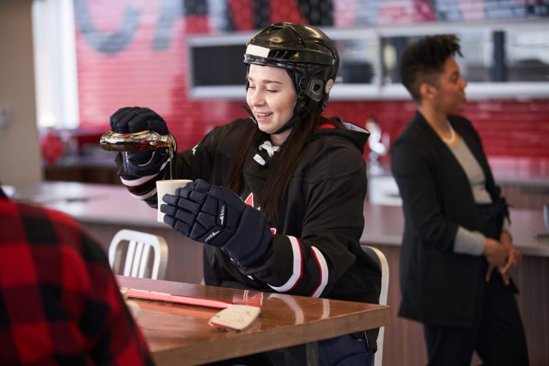 Hockey player enjoys refreshing glass of maple syrup