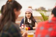 Woman raises glass of beer to celebrate