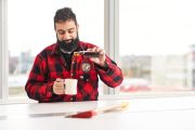 Lumberjack enjoys glass of maple syrup