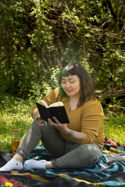 Woman reading a book at a picnic